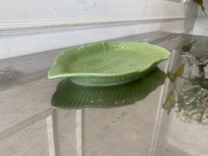 Ceramic plate with a green banana leaf design.