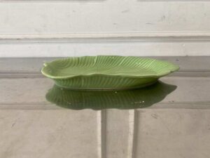 Ceramic plate with a green banana leaf design.