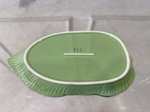 Ceramic plate with a green banana leaf design.