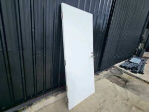 White wooden door with lever doorknob.