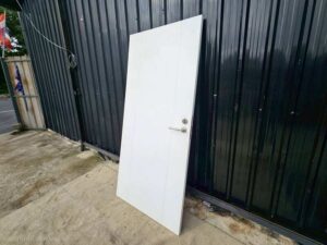 White wooden door with lever doorknob.