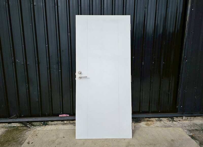 White wooden door with lever doorknob.