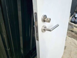 White wooden door with lever doorknob.