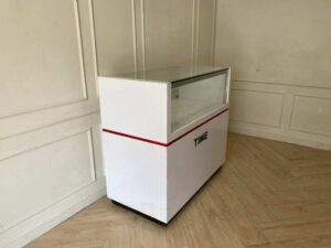 White glass display cabinet with red trim