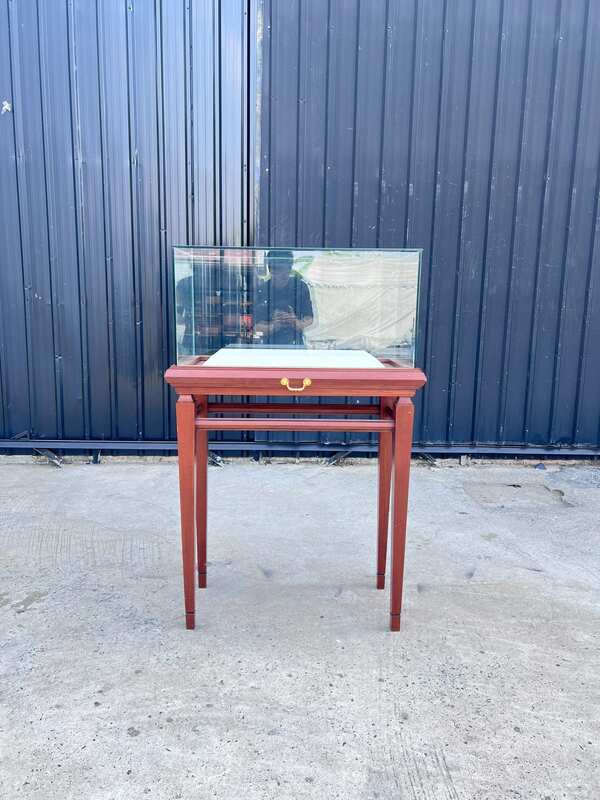 Glass display case with wooden legs and 1 sliding track. Wood color.