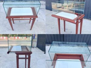 Glass display case with wooden legs and 1 sliding track. Wood color.