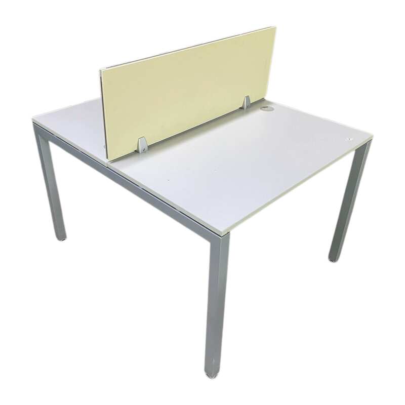 Two-seater group workstation with grey steel legs, cream-colored partition, and power strip.