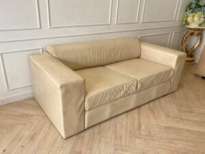 Two-seater sofa, cream leather upholstery.