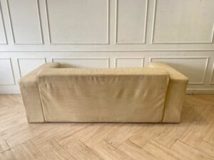 Two-seater sofa, cream leather upholstery.