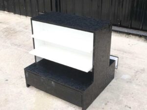 Wooden product shelf, 2 sides, 3 shelves on each side, 1 drawer, black wood frame with triangular pattern._52XAM9MFQT