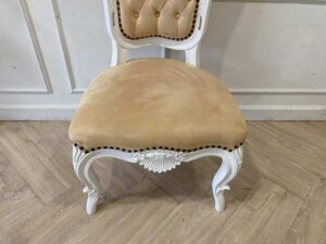 Single-seat Louis-style wooden chair with yellow button-tufted fabric upholstery.
