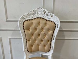 Single-seat Louis-style wooden chair with yellow button-tufted fabric upholstery.
