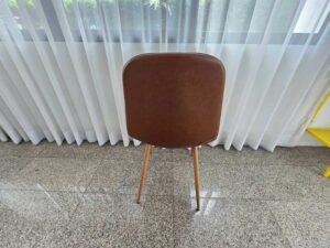 Brown leather-upholstered dining chair with wooden legs (2)