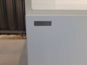 Moflex brand white 2-drawer filing cabinet with 1 storage compartment.