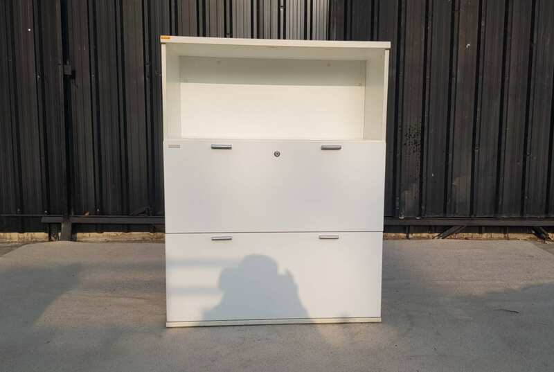 Moflex brand white 2-drawer filing cabinet with 1 storage compartment.