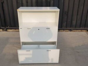 Moflex brand white 2-drawer filing cabinet with 1 storage compartment.