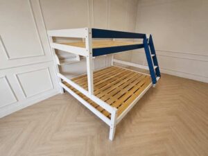 White and blue wooden bunk bed for children with shelves.