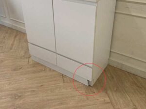 White wooden shoe cabinet with two doors and two drawers.