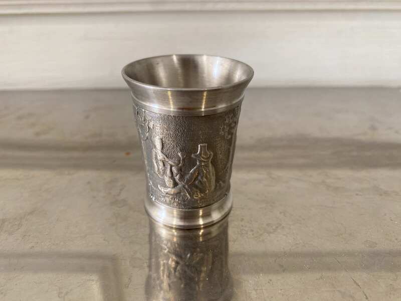 Drinking glass made of pure tin, with low-relief embossed patterns depicting daily life.