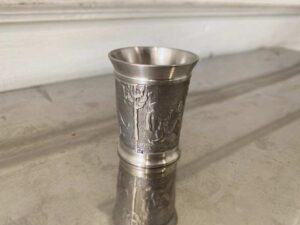 Drinking glass made of pure tin, with low-relief embossed patterns depicting daily life.