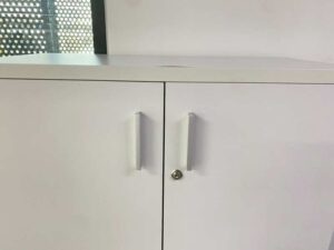 Tall filing cabinet with 2 doors, gray color.
