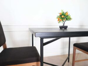 Table with black wood top, black steel legs, table top carved with gold stainless steel pattern._7MOYMHFGPW