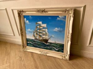 Oil painting of a pirate ship sailing in the ocean.