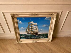 Oil painting of a pirate ship sailing in the ocean.