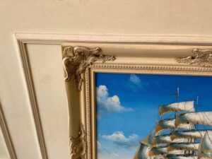 Oil painting of a pirate ship sailing in the ocean.