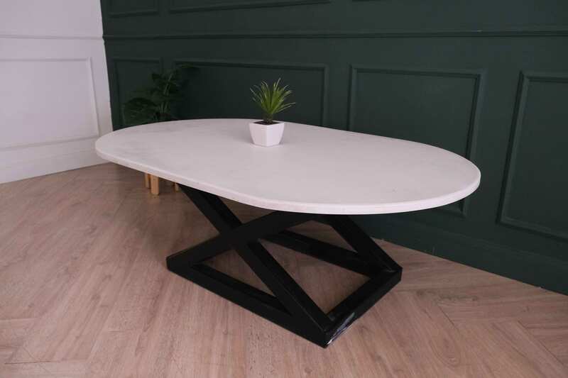 Central table, white wooden top, thick black steel frame, curved corners._88CU3KN5KJ