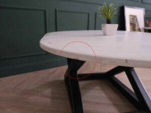 Central table, white wooden top, thick black steel frame, curved corners._88CU3KN5KJ