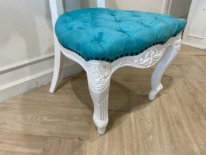 Single-seat Louis-style wooden chair with blue button-tufted fabric upholstery.
