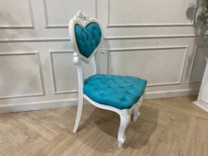 Single-seat Louis-style wooden chair with blue button-tufted fabric upholstery.