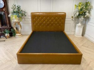 5-foot bed with leather cushions and brown button-tufted bolsters