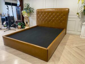 5-foot bed with leather cushions and brown button-tufted bolsters