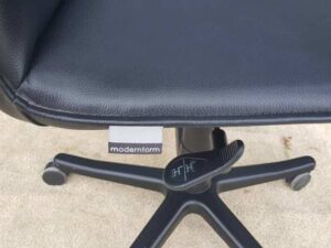 Modernform brand office chair, black leather seat and steel legs, 102 cm high.