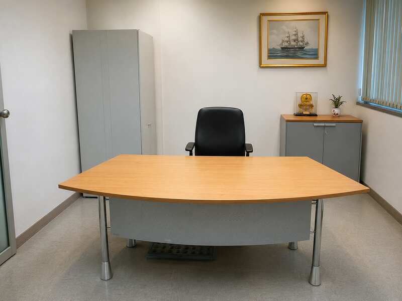 Curved-top office desk with light brown wood top and steel legs, MOFLEX brand.