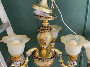 Vintage style chandelier with rose pattern, gold color.