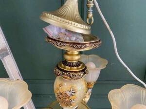 Vintage style chandelier with rose pattern, gold color.