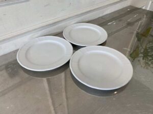 White ceramic dinner plate, Royal Porcelain brand.