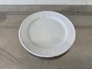 White ceramic dinner plate, Royal Porcelain brand.