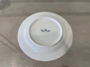 White ceramic dinner plate, Royal Porcelain brand.