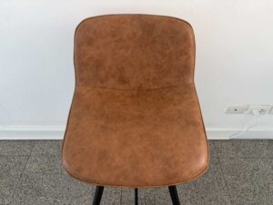 Brown leather bar stool with black wooden legs