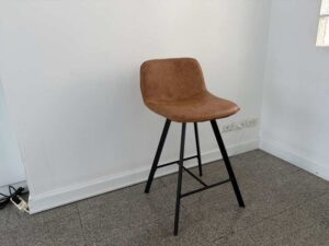 Brown leather bar stool with black wooden legs