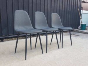 Chair with metal legs and dark gray fabric seat.