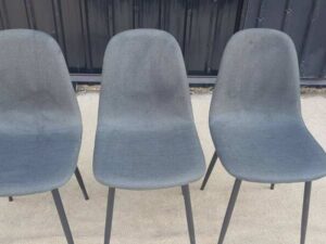 Chair with metal legs and dark gray fabric seat.