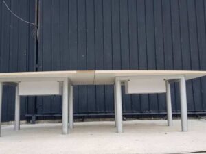 12-seat conference table, steel legs with power strip, light brown wood top (2)