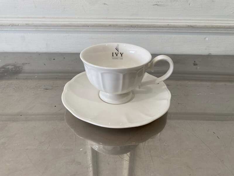 White ceramic coffee cup set with saucer.