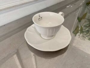 White ceramic coffee cup set with saucer.