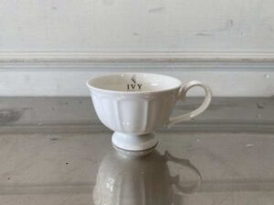 White ceramic coffee cup set with saucer.